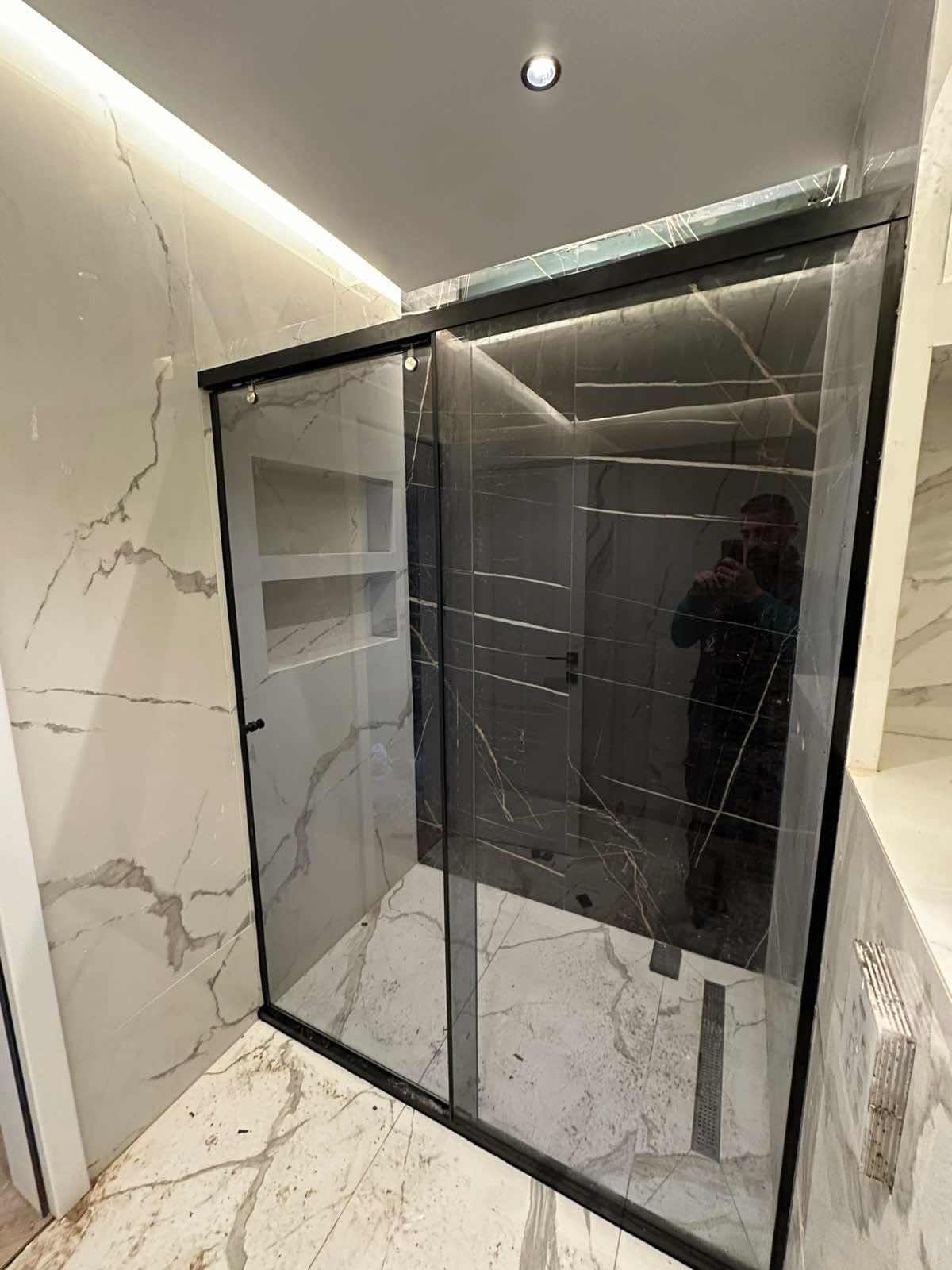 Frameless marble walk-in shower enclosure