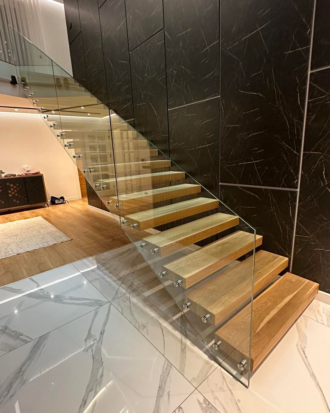Frameless glass balustrade on a floating oak staircase